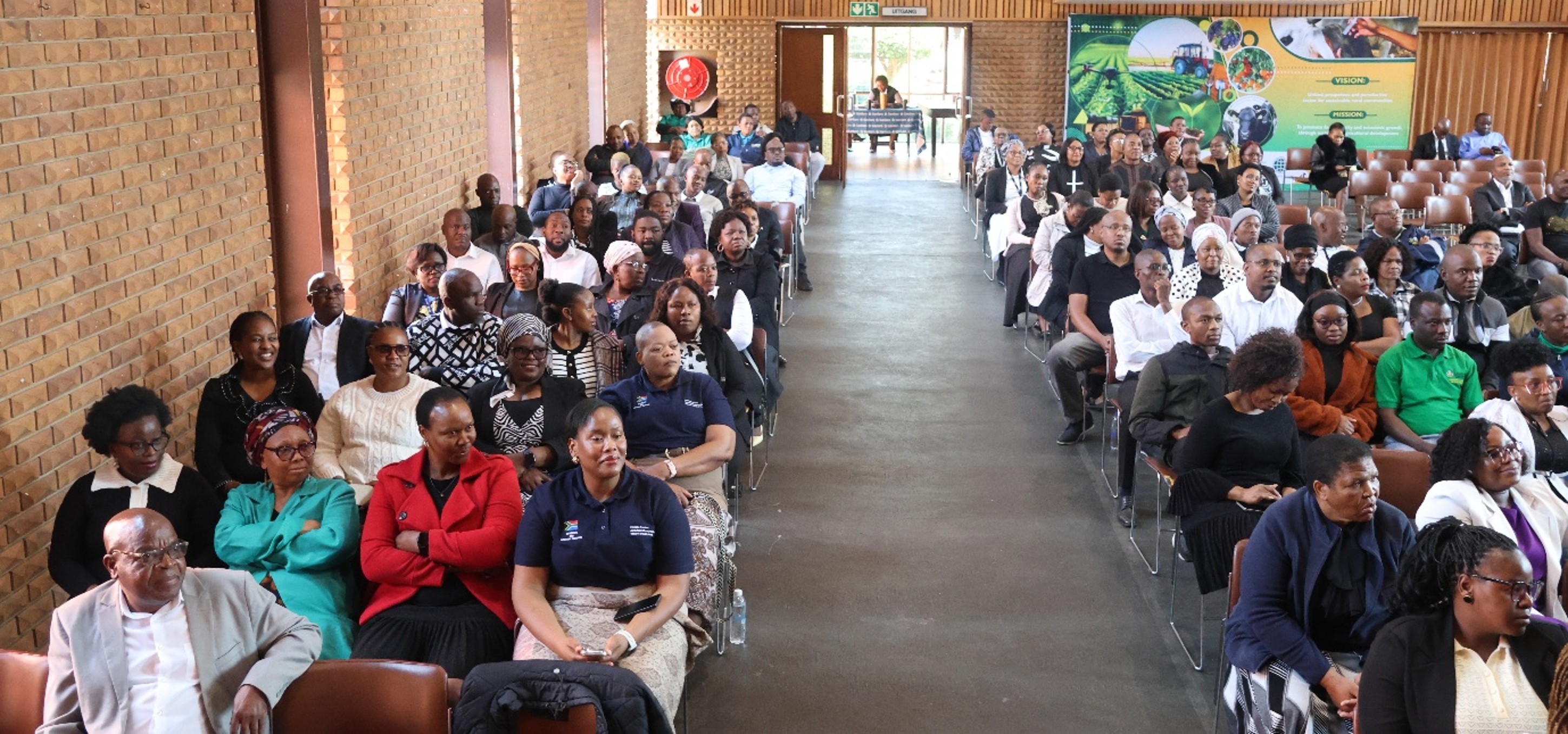 Employees from Head Office listen attentively to leadership. 